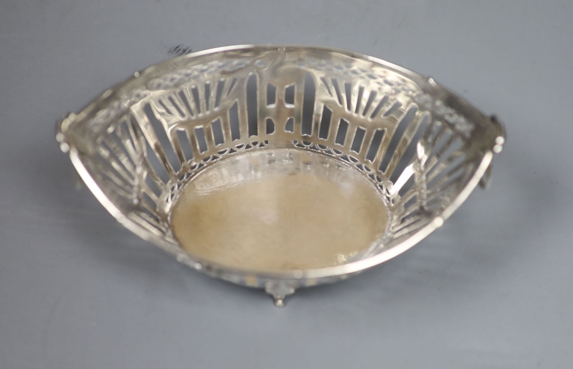 A late 19th/early 20th century Dutch pierced white metal ring handled navette shaped basket